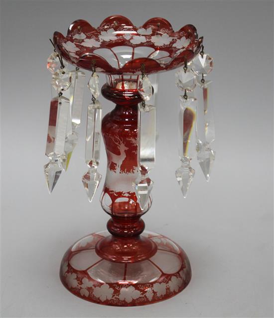 A late 19th century Bohemian ruby overlaid glass table lustre, with spear shaped drops and engraved with a stag, height 25cm